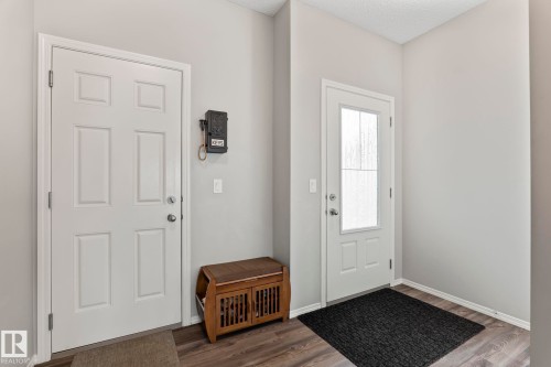 The property features light gray walls and dark wood flooring - 5164 Lark Crescent Nw, Edmonton, AB - Indoor Photo Showing Other Room