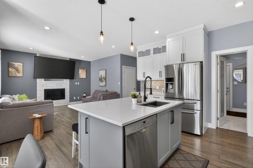 457 Meadowview Drive, Fort Saskatchewan, AB - Indoor Photo Showing Kitchen With Fireplace With Stainless Steel Kitchen With Upgraded Kitchen