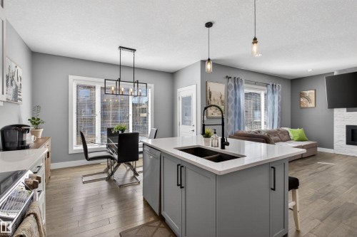 457 Meadowview Drive, Fort Saskatchewan, AB - Indoor Photo Showing Kitchen With Fireplace With Double Sink