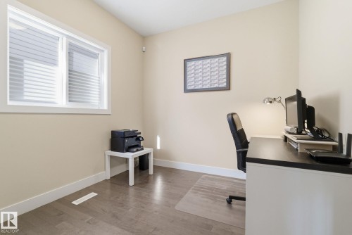 This room features light-colored walls and hardwood-style flooring - 3235 Abbott Crescent, Edmonton, AB - Indoor Photo Showing Office