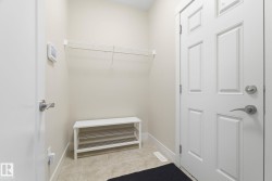 Entryway with tiled flooring and a white paneled door - 