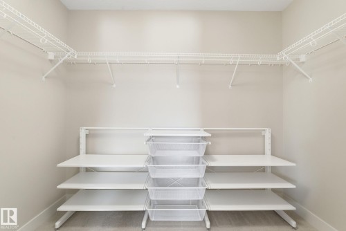 The property offers a closet with extensive white wire shelving and a central column of wire drawers, providing ample storage solutions - 3235 Abbott Crescent, Edmonton, AB - Indoor With Storage