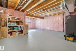 The property features exposed wooden ceiling beams and a painted concrete floor, with a window providing natural light - 