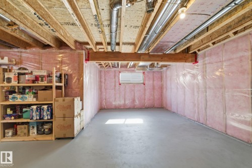 The property features a spacious unfinished basement with exposed wooden joists and insulated walls, offering potential for future customization - 3235 Abbott Crescent, Edmonton, AB - Indoor Photo Showing Basement