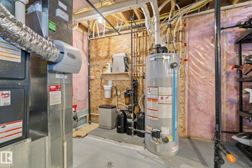 The utility space features a water heater, a water filtration system, and HVAC components - 3235 Abbott Crescent, Edmonton, AB - Indoor Photo Showing Basement