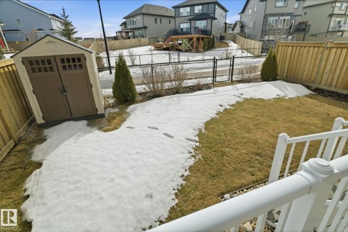 The property features a backyard with a lawn, a storage shed, and a privacy fence - 3235 Abbott Crescent, Edmonton, AB - Outdoor