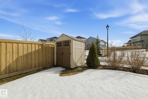 The property features a private yard with a wood fence and a storage shed - 3235 Abbott Crescent, Edmonton, AB - Outdoor