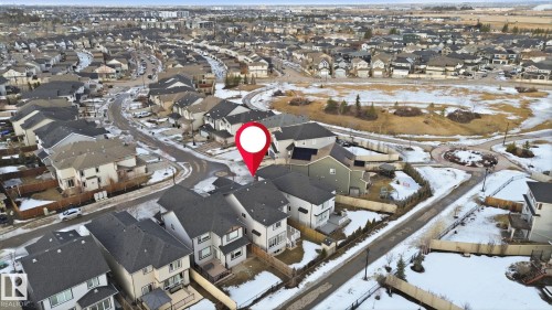 An aerial view showcasing the property's advantageous location within a residential area, surrounded by other properties and an open field - 3235 Abbott Crescent, Edmonton, AB - Outdoor With View