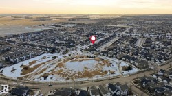 Aerial view of the property's community, showcasing the residential area with established homes and streets - 