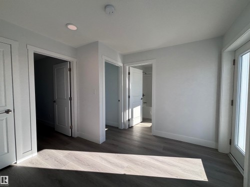 This property features light gray walls, recessed lighting, and a light-toned wood-look flooring - 2740 Blatchford Road, Edmonton, AB - Indoor Photo Showing Other Room