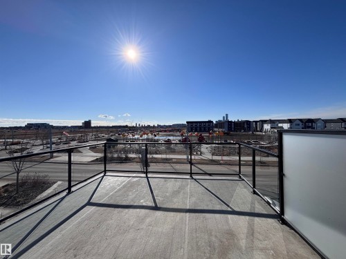 The property features a balcony with glass railings and a textured surface - 2740 Blatchford Road, Edmonton, AB - Outdoor With View