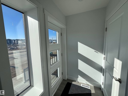 Entryway featuring a window with views of the surrounding neighborhood and a door with three rectangular glass inserts - 2740 Blatchford Road, Edmonton, AB - Indoor Photo Showing Other Room