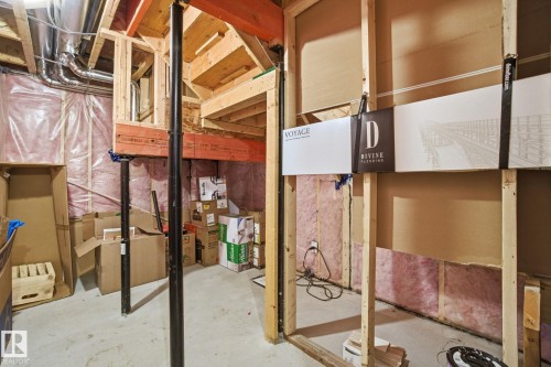 The property features exposed wooden framing, ductwork, and insulation, indicating potential for customization - 1607 202 Street, Edmonton, AB - Indoor Photo Showing Basement