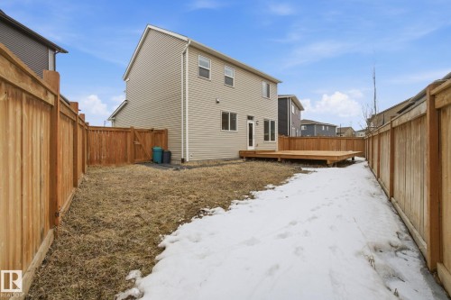 The property features a private yard with a wooden fence and a wooden deck - 1607 202 Street, Edmonton, AB - Outdoor With Exterior