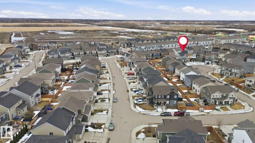 Aerial view of the property and its surrounding neighborhood, featuring a structured street layout with houses exhibiting varied exterior finishes and rooflines - 1607 202 Street, Edmonton, AB - Outdoor With View