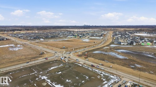 Aerial view of the surrounding neighborhood showcasing houses, roads, and open land - 1607 202 Street, Edmonton, AB - Outdoor With View