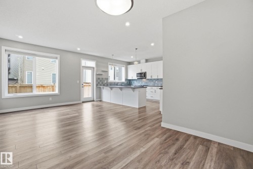 Open concept living space featuring wide plank flooring, recessed lighting, and large windows - 1607 202 Street, Edmonton, AB - Indoor