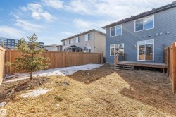 The property features a fenced yard, a rear deck, and a sliding glass patio door - 