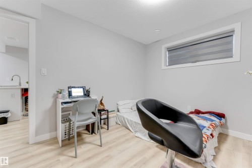The room features light-colored flooring and a window with blinds - 1663 Cavanagh Boulevard Sw, Edmonton, AB - Indoor