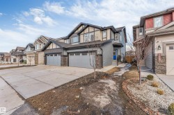 The property features a two-story exterior with grey siding and dark trim accents - 