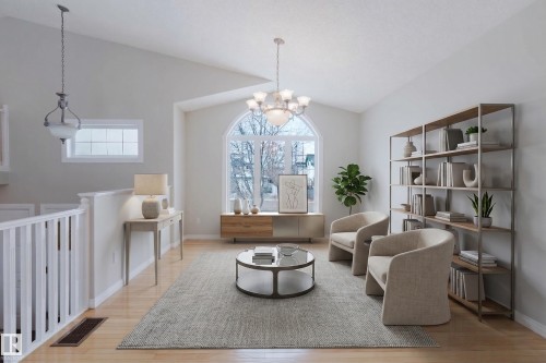 This bright living area features vaulted ceilings, hardwood floors, and a large arched window that provides natural light - 1641 Forbes Way, Edmonton, AB - Indoor