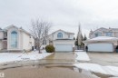 The property features a two-story design, an attached garage, and a paved driveway - 1641 Forbes Way, Edmonton, AB  - Outdoor With Facade 