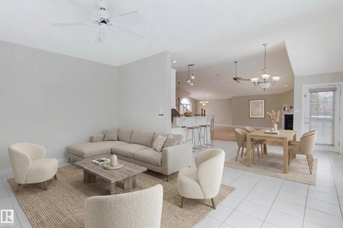 The property features an expansive open-concept living area with a ceiling fan, light-toned walls, and white tile flooring - 1641 Forbes Way, Edmonton, AB - Indoor Photo Showing Living Room