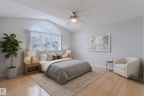 This room features hardwood floors and a vaulted ceiling with a ceiling fan - 1641 Forbes Way, Edmonton, AB - Indoor Photo Showing Bedroom