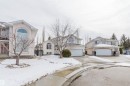 The property features a two-story design with a two-car garage and a paved driveway - 1641 Forbes Way, Edmonton, AB  - Outdoor With Facade 
