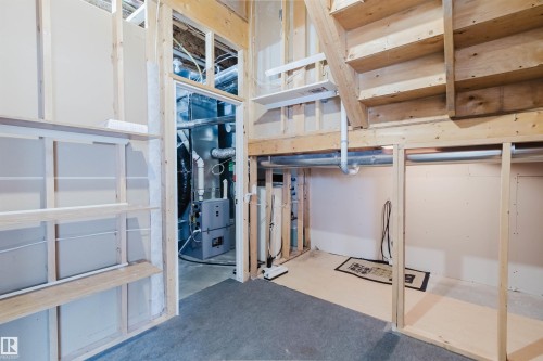 The property features exposed wooden framing, an unfinished utility area, and a staircase - 1641 Forbes Way, Edmonton, AB - Indoor