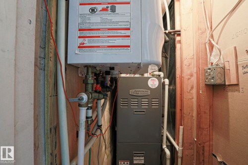 Utility closet featuring a water heater and furnace - 9319 92 Street, Edmonton, AB - Indoor Photo Showing Basement