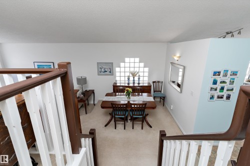 The property features a dining area with a hardwood dining table, surrounded by a carpeted floor - 322 Pearson Crescent, Edmonton, AB - Indoor Photo Showing Other Room