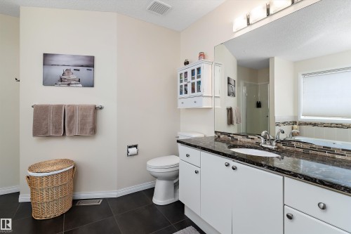 Bathroom featuring a white vanity with a dark countertop and a large mirror - 322 Pearson Crescent, Edmonton, AB - Indoor Photo Showing Bathroom
