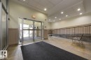 Well-lit interior space featuring tile flooring, a ramp with a handrail, and entrance doors - 209 10235 112 Street, Edmonton, AB  - Indoor Photo Showing Other Room 