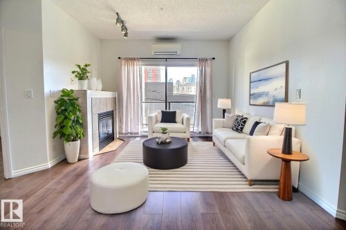 Virtually Staged - 209 10235 112 Street, Edmonton, AB - Indoor Photo Showing Living Room With Fireplace