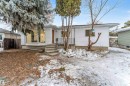 The property features a white exterior, a prominent bay window, and a concrete staircase leading to the entrance - 12423 91 Street, Edmonton, AB  - Outdoor 