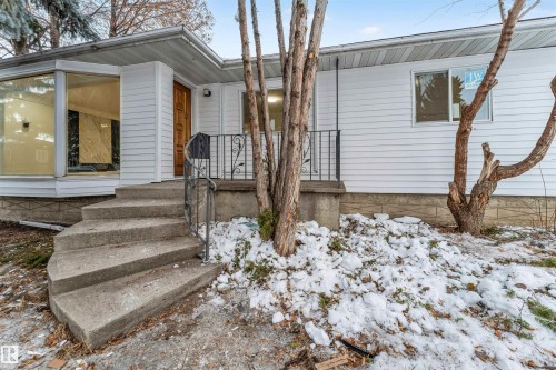 The property features white siding and a brown front door - 12423 91 Street, Edmonton, AB - Outdoor
