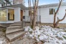 The property features white siding and a brown front door - 12423 91 Street, Edmonton, AB  - Outdoor 
