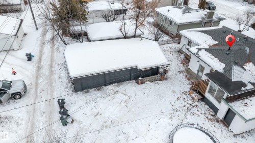 Aerial view showcasing the property with a white exterior, a dark shingled roof, and a visible deck - 12423 91 Street, Edmonton, AB - Outdoor