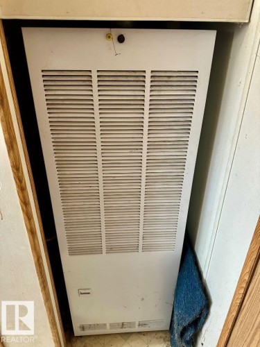 Utility area featuring a wall-mounted unit with a louvered panel - 50124 Range Road 203, Rural Beaver County, AB - Indoor Photo Showing Other Room