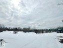 Expansive property with a snow-covered yard and a cluster of bare trees in the distance - 50124 Range Road 203, Rural Beaver County, AB  - Outdoor With View 