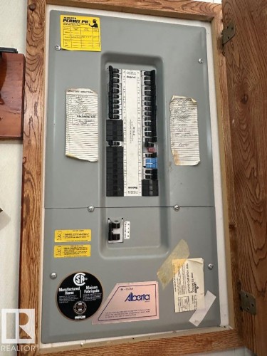Electrical panel housed within a wood-framed cabinet - 50124 Range Road 203, Rural Beaver County, AB - Indoor Photo Showing Basement