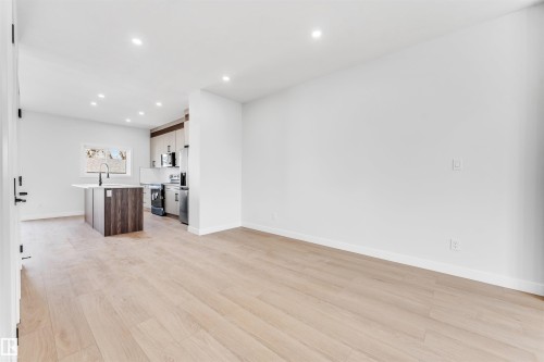 Open concept living area featuring light wood flooring, white walls, and recessed lighting - 10962 157 Street, Edmonton, AB - Indoor