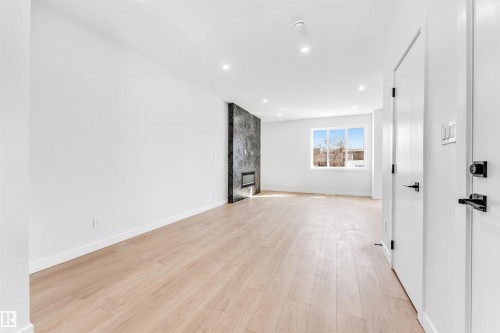 Open concept living area featuring light wood flooring and recessed lighting - 10962 157 Street, Edmonton, AB - Indoor Photo Showing Other Room