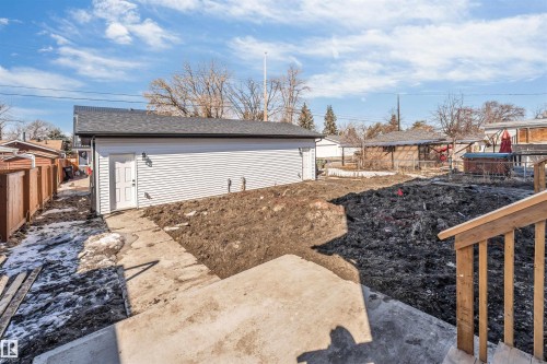 The property features a detached garage with horizontal siding and a side entry door - 10962 157 Street, Edmonton, AB - Outdoor