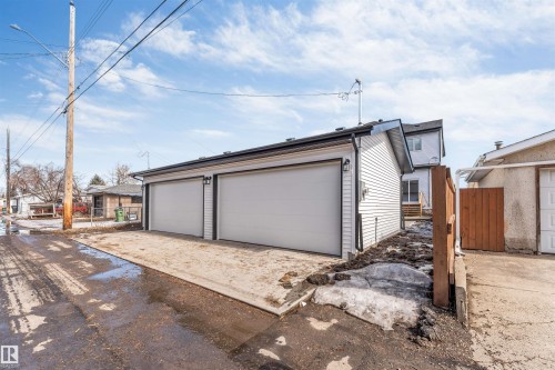 This property features a detached two-car garage with white siding and a concrete pad - 10962 157 Street, Edmonton, AB - Outdoor With Exterior