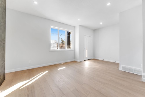 The property features light-toned wood flooring, white walls, and recessed lighting - 10962 157 Street, Edmonton, AB - Indoor Photo Showing Other Room