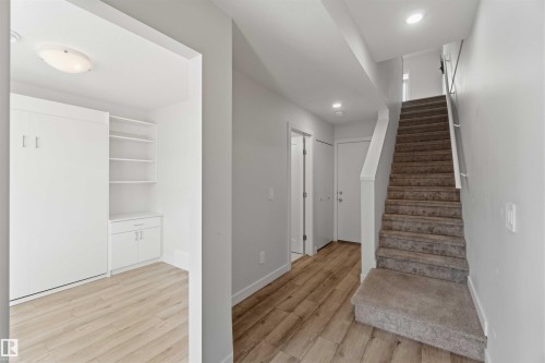 Entryway featuring light-toned flooring, recessed lighting, and a staircase with carpeted treads - 49 100 Jensen Lakes Boulevard, St. Albert, AB - Indoor Photo Showing Other Room
