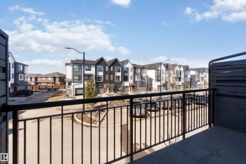 Balcony with black metal railings and a privacy screen, providing views of the community - 49 100 Jensen Lakes Boulevard, St. Albert, AB - Outdoor
