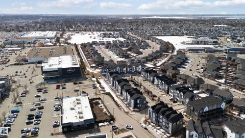 Aerial view showcasing a residential area with varied housing types and nearby commercial establishments - 49 100 Jensen Lakes Boulevard, St. Albert, AB - Outdoor With View